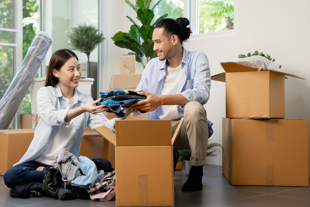 Couple packing various items into boxes